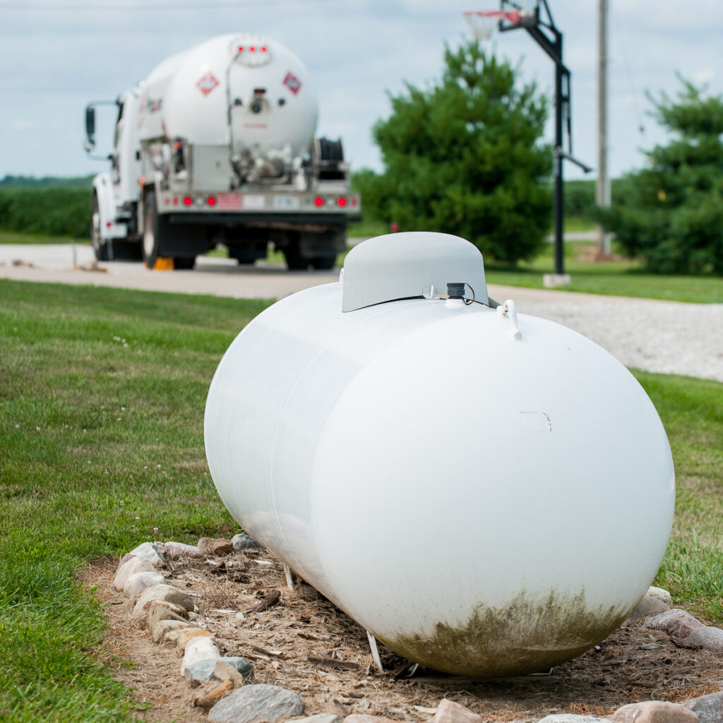 propane delivery vehicle near propane tank